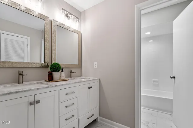 a white toilet sitting next to a bath tub