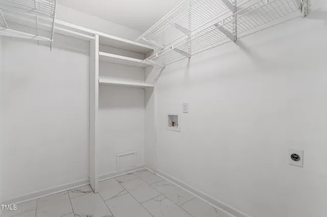 a view of a house with a door and a tree