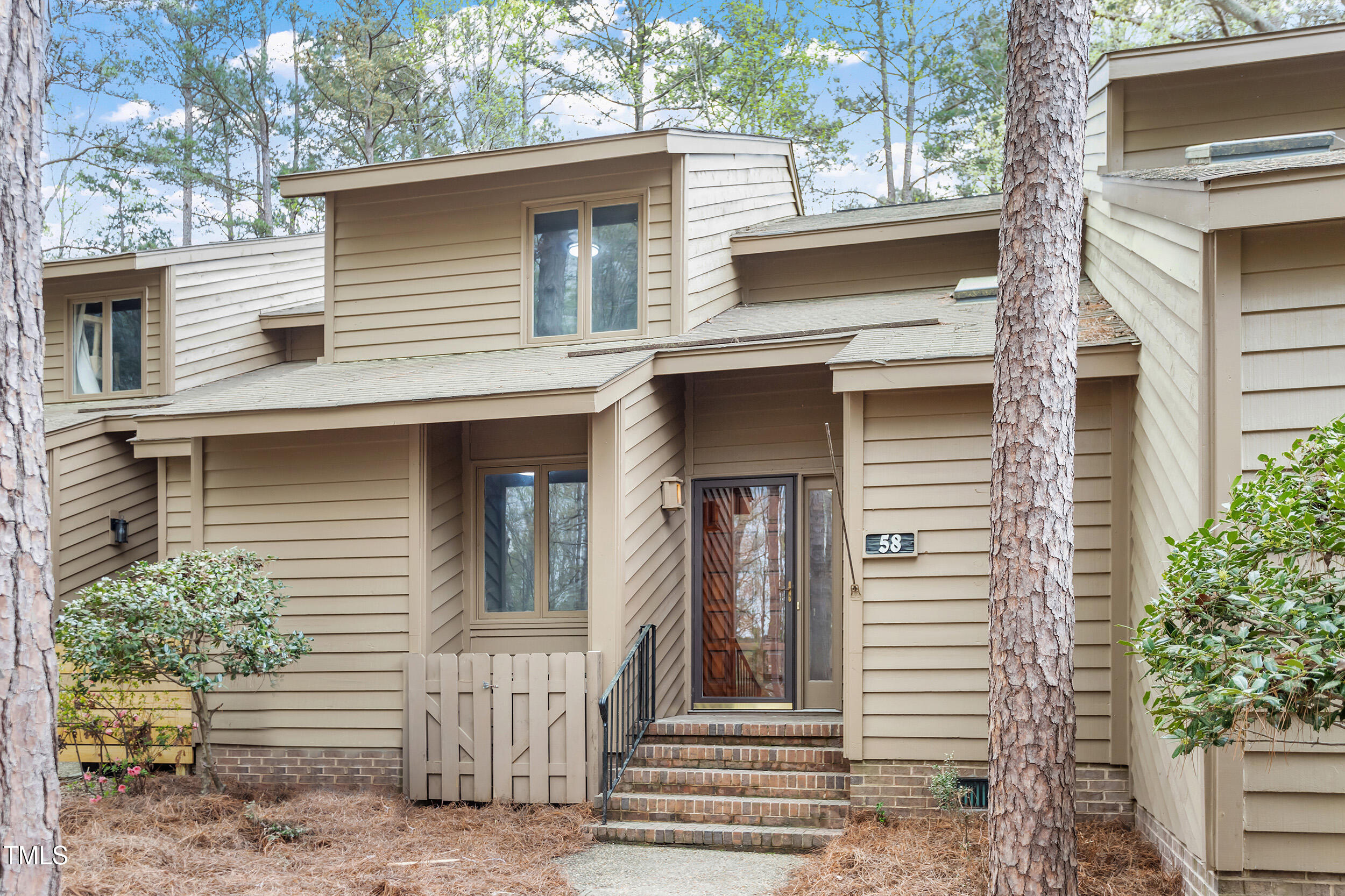 58 Stoneridge Road Durham, NC 27705 - Photo 30 of 38 a view of a house with a door and a tree