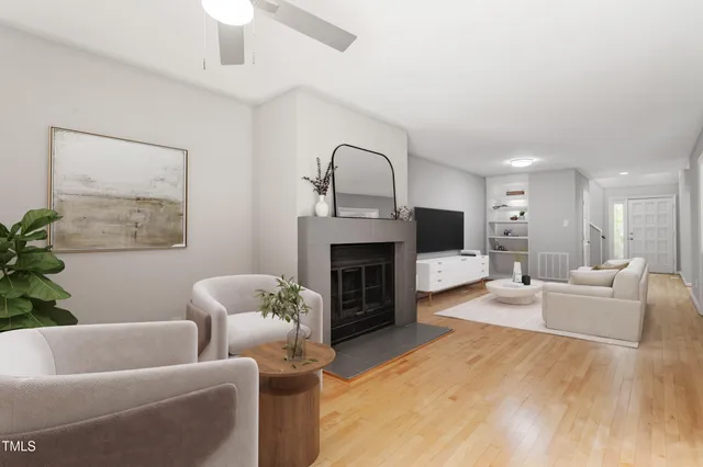 a living room with furniture a window and a fireplace