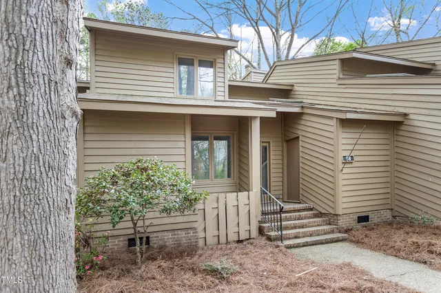 a view of a house with wooden fence