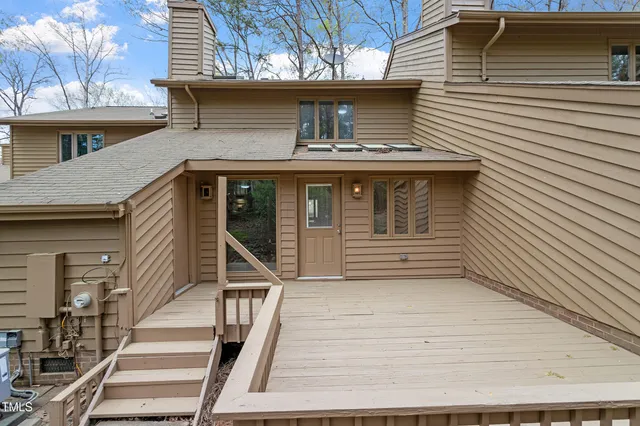 a view of a wooden deck with a yard