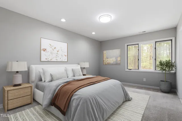 a bedroom with a large bed and a large window