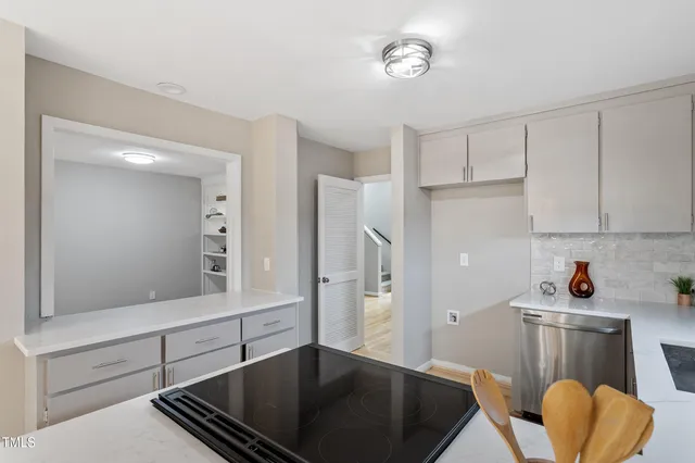 a kitchen with cabinets and a refrigerator