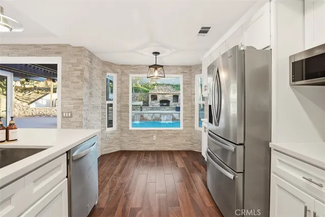 a kitchen with stainless steel appliances a refrigerator and a sink