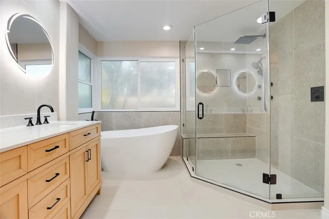 a bathroom with a shower a sink and a mirror