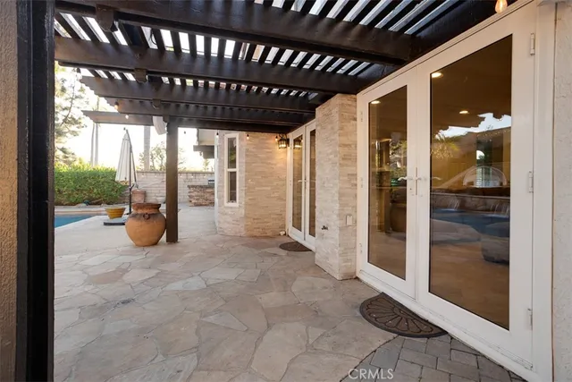 a view of a porch with a table and chairs