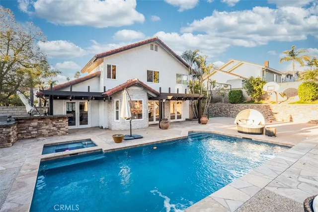 a front view of a house with swimming pool having outdoor seating
