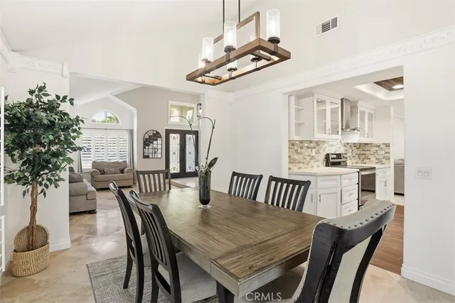 a view of a dining room with furniture and chandelier