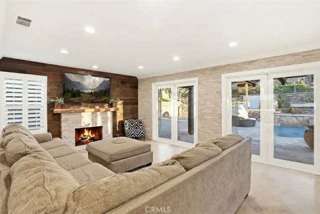 a living room with fireplace furniture and a flat screen tv