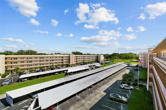 a view of swimming pool with outdoor seating and city view