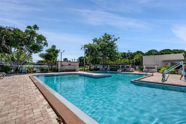 a view of a house with swimming pool and a yard