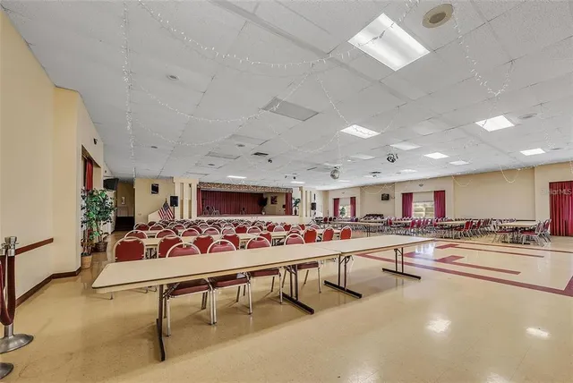 a living room with furniture a flat screen tv and kitchen view