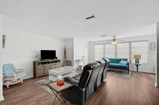 a bedroom with furniture and a flat screen tv