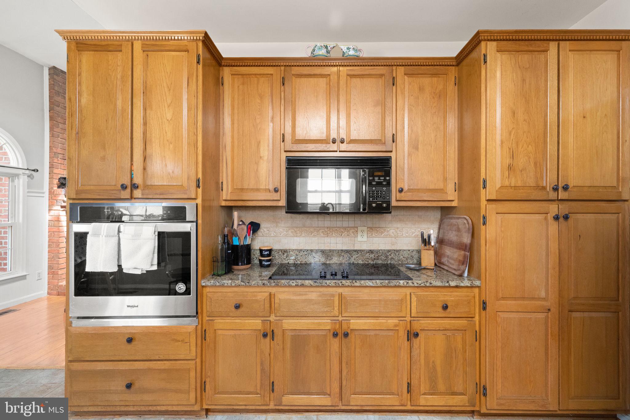 2140 Marston Road New Windsor, MD 21776 - Photo 13 of 48 a kitchen with stainless steel appliances granite countertop white cabinets and a refrigerator with wooden floor