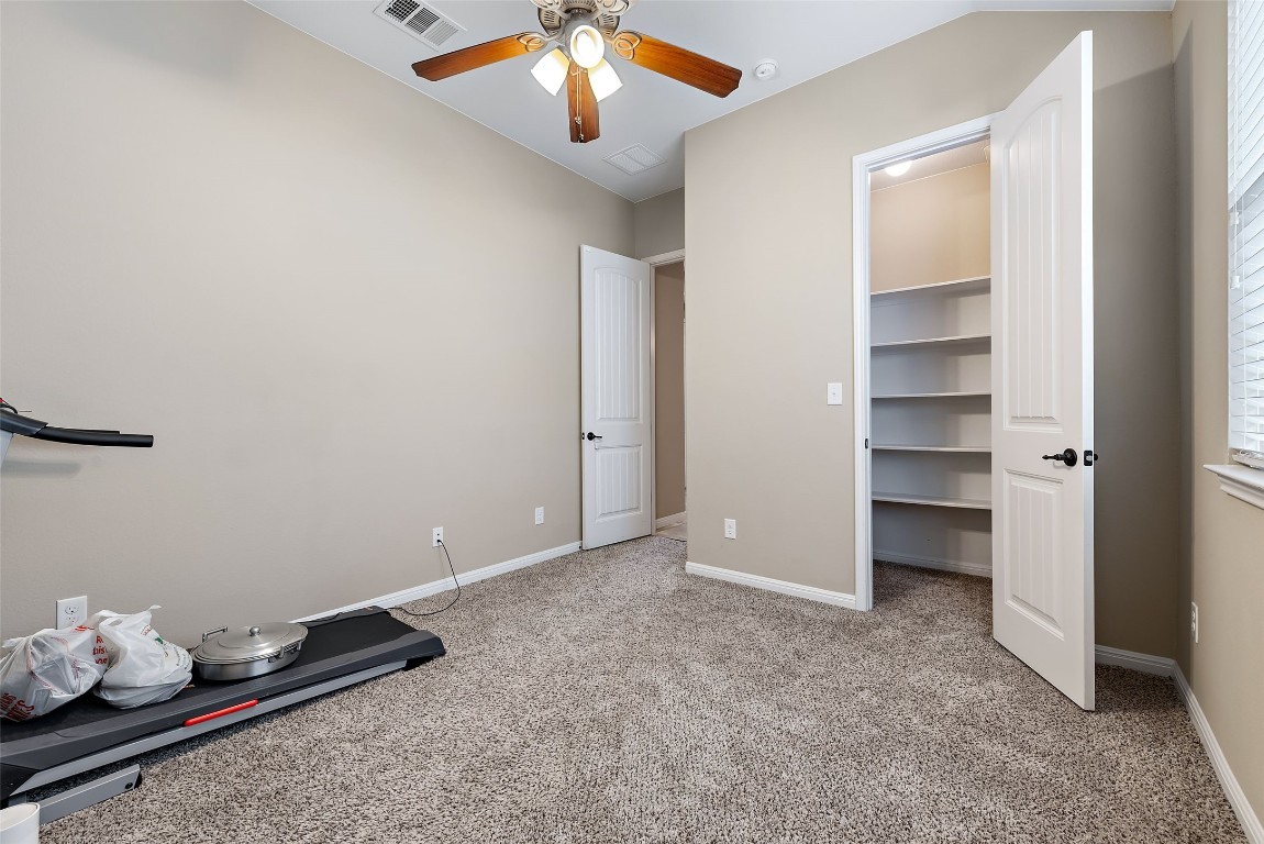 2000 Manada Trail Leander, TX 78641 - Photo 28 of 36 A well-lit interior space features soft carpeting and convenient closet shelving.