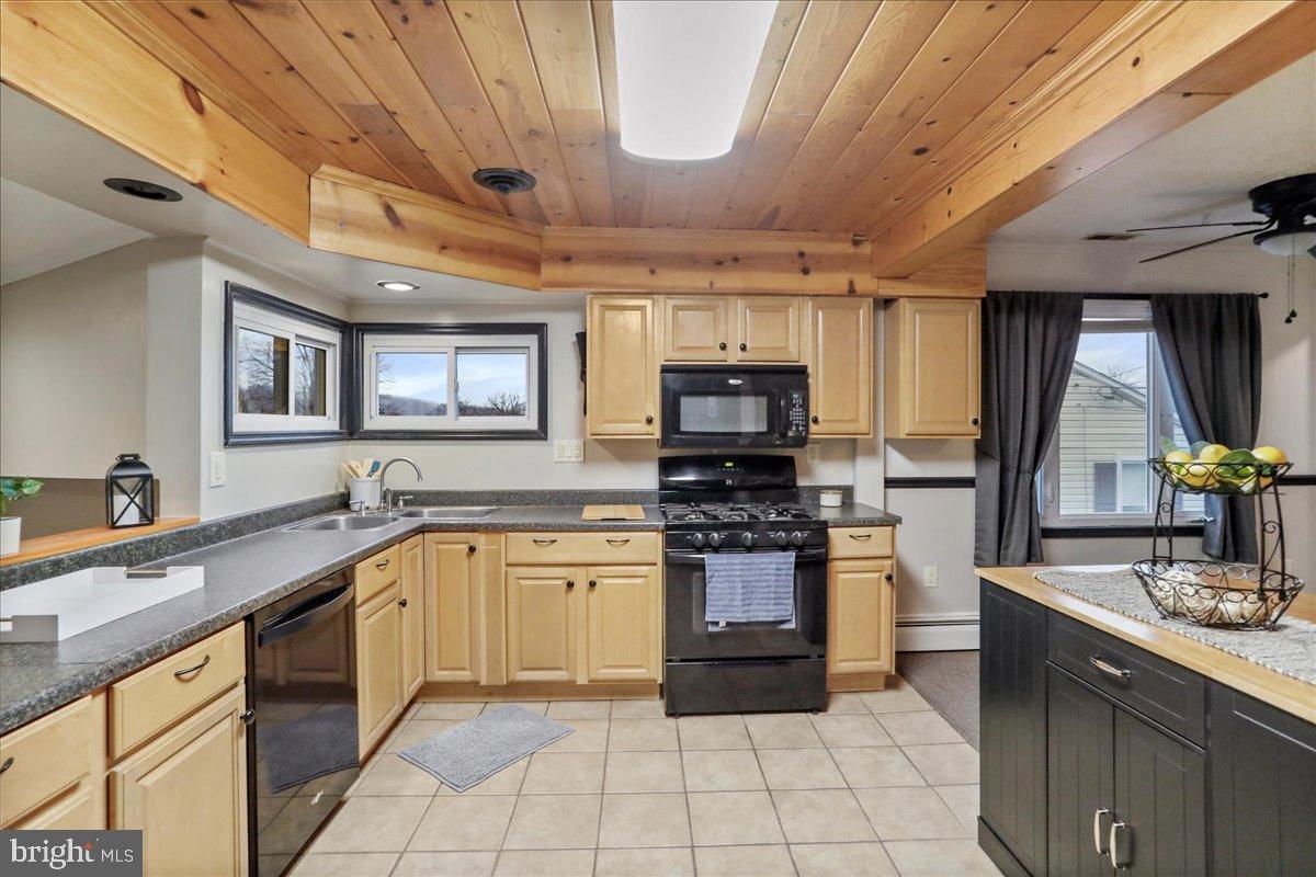 13815 Brant Road Southwest Cresaptown, MD 21502 - Photo 12 of 40 a kitchen with stainless steel appliances granite countertop a sink counter space cabinets and a large window