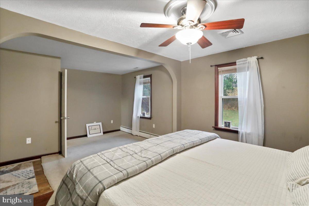 13815 Brant Road Southwest Cresaptown, MD 21502 - Photo 16 of 40 a bedroom with a bed and a chandelier