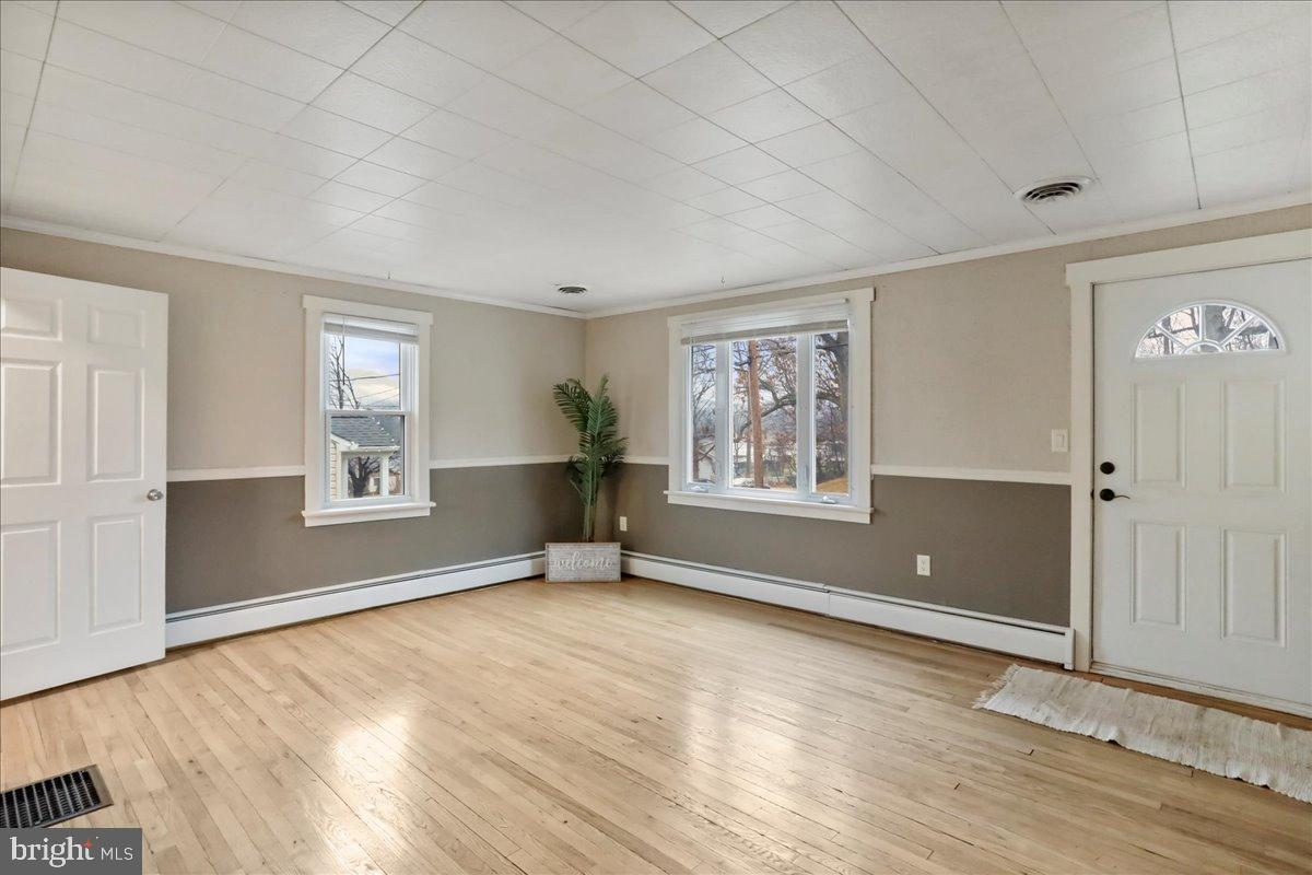 13815 Brant Road Southwest Cresaptown, MD 21502 - Photo 6 of 40 an empty room with wooden floor and windows