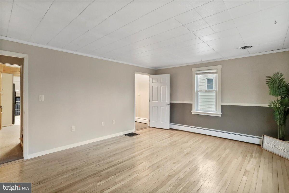 13815 Brant Road Southwest Cresaptown, MD 21502 - Photo 7 of 40 an empty room with wooden floor and windows