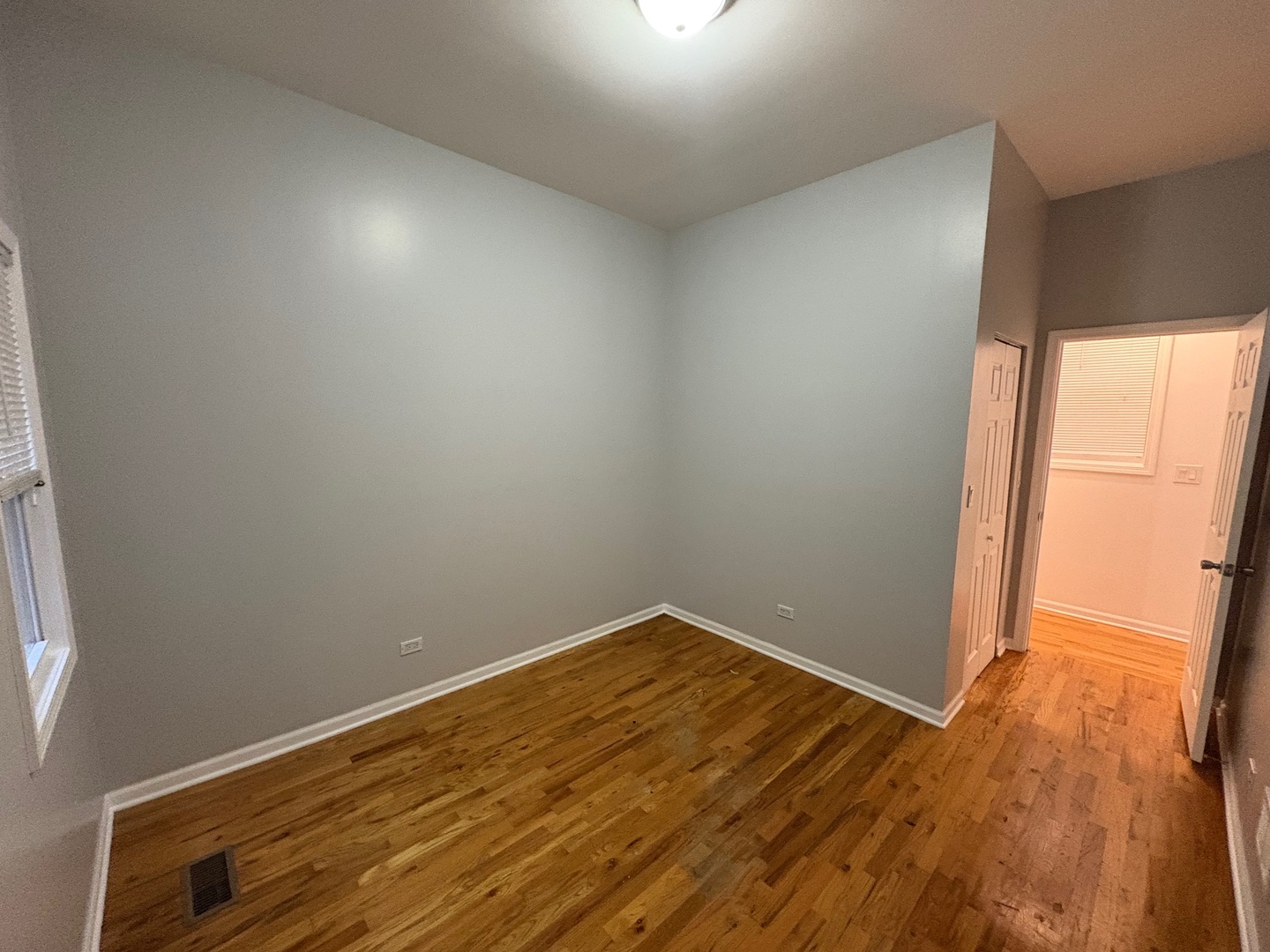 524 West 78th Street, Unit 1 Chicago, IL 60620 - Photo 9 of 9 an empty room with wooden floor and windows