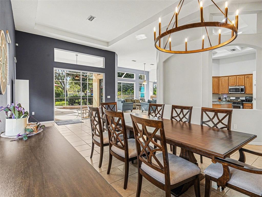 8443 Sailing Loop Lakewood Ranch, FL 34202 - Photo 12 of 34 a dining room with furniture a window and a chandelier