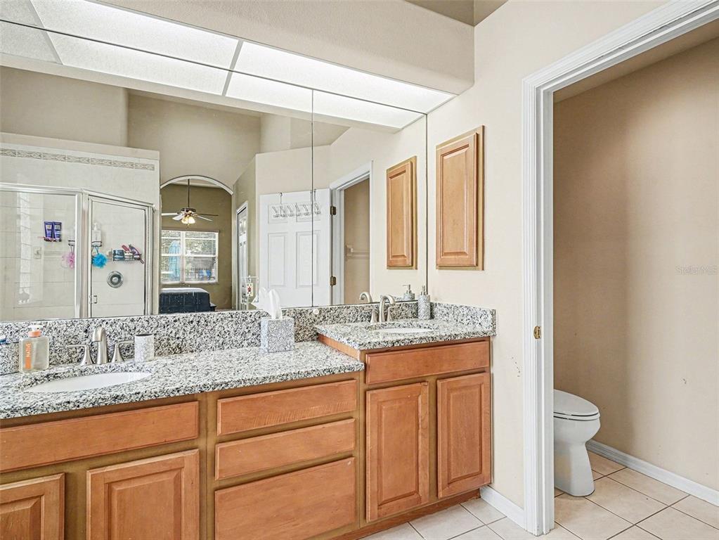 8443 Sailing Loop Lakewood Ranch, FL 34202 - Photo 23 of 34 a bathroom with a granite countertop sink and a mirror
