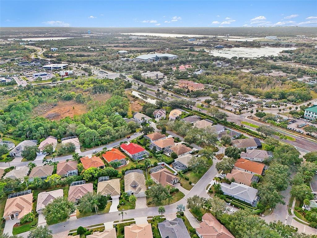8443 Sailing Loop Lakewood Ranch, FL 34202 - Photo 33 of 34 an aerial view of residential houses with outdoor space and ocean view