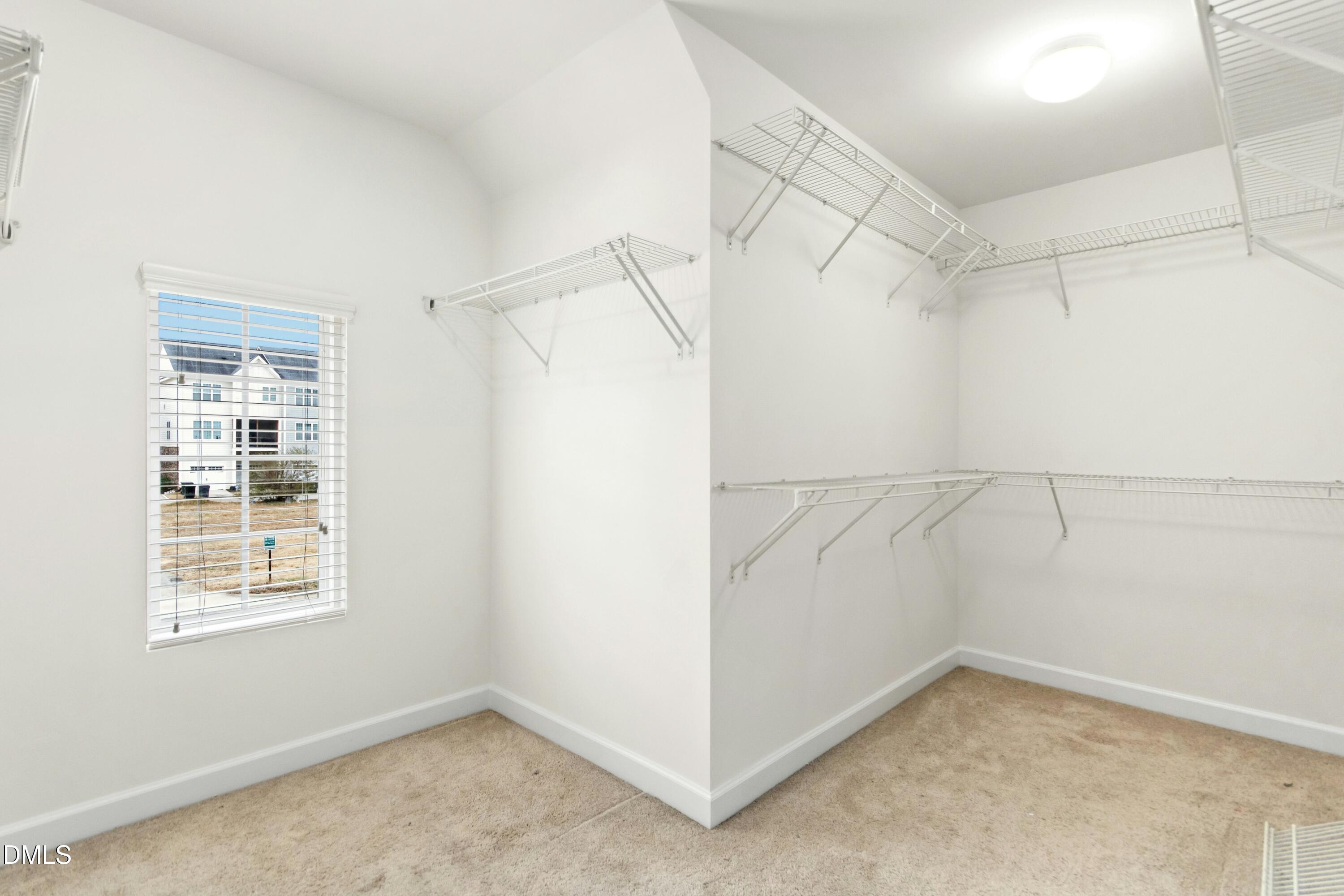 125 Spring Pine Lane Holly Springs, NC 27540 - Photo 22 of 34 an empty room with windows