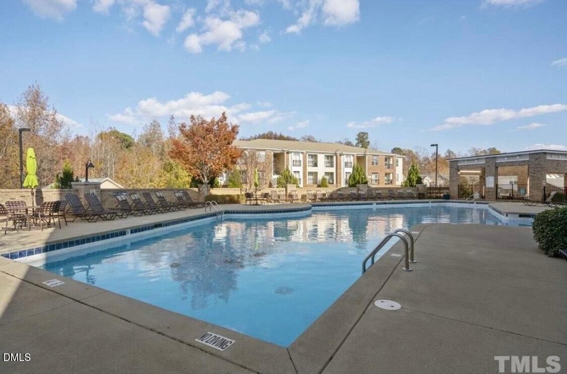 125 Spring Pine Lane Holly Springs, NC 27540 - Photo 30 of 34 a view of swimming pool with outdoor seating and city view