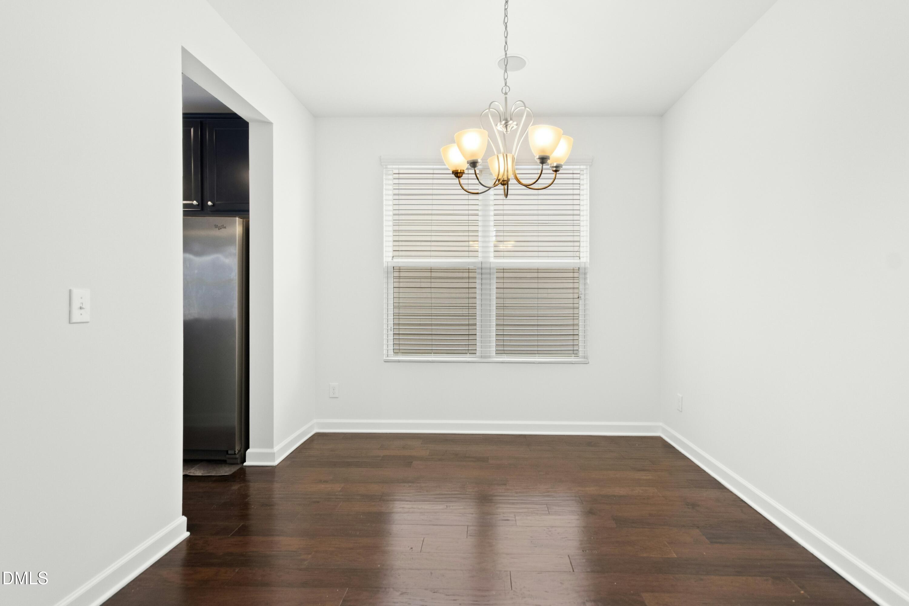 125 Spring Pine Lane Holly Springs, NC 27540 - Photo 6 of 34 a view of livingroom with chandelier wooden floor and chandelier