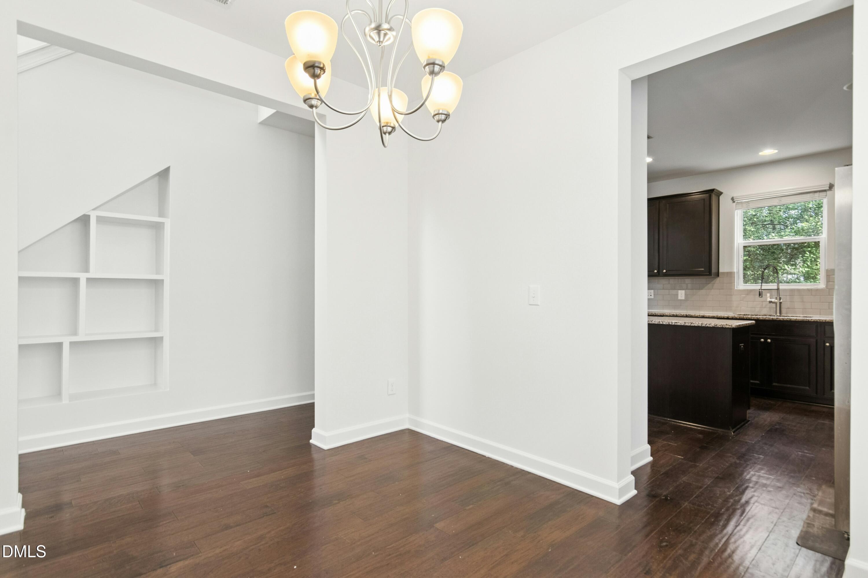 125 Spring Pine Lane Holly Springs, NC 27540 - Photo 7 of 34 a view of a kitchen from the hallway
