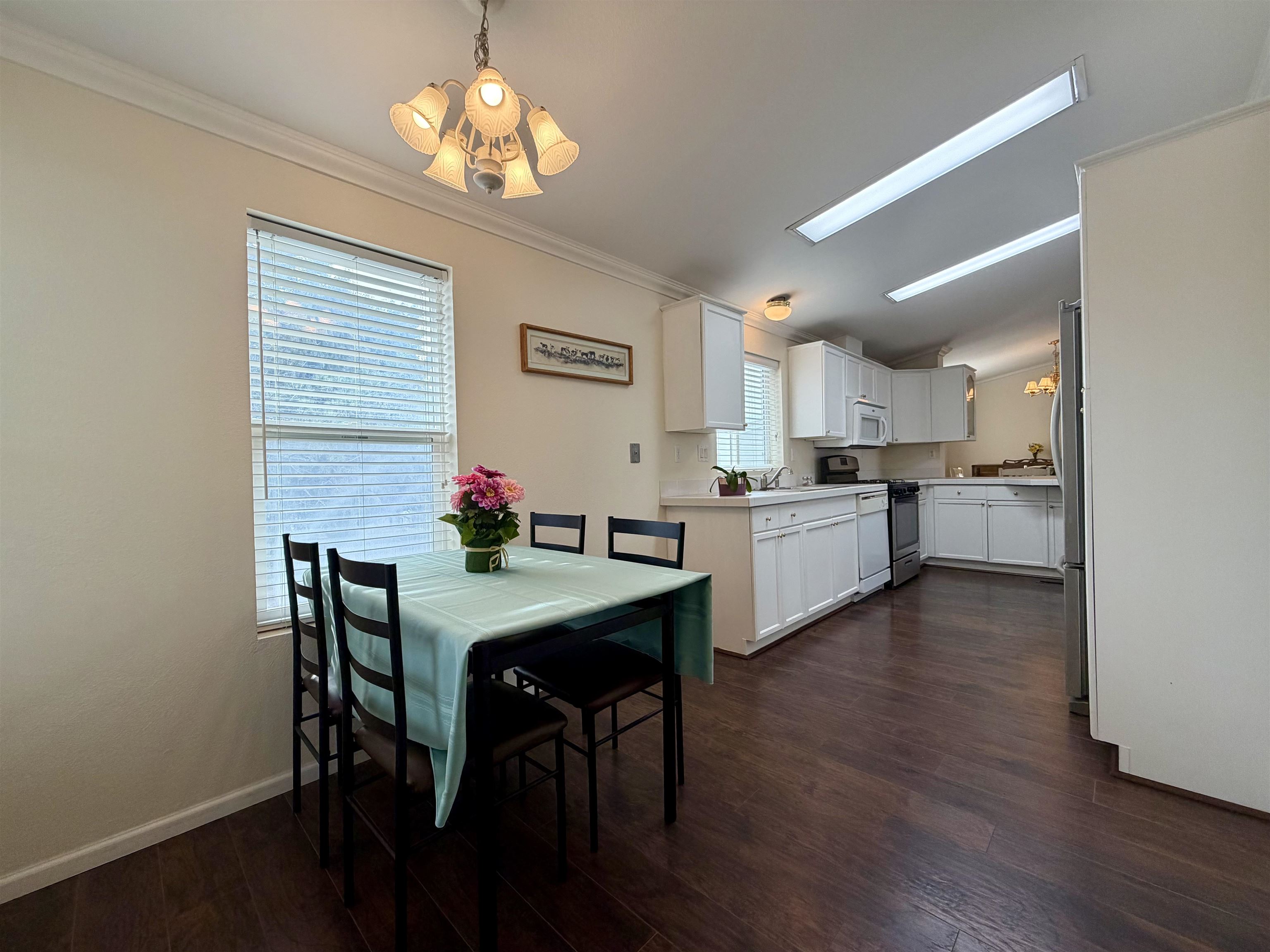 435 32 Road, Unit 480 Clifton, CO 81520 - Photo 11 of 23 a kitchen with stainless steel appliances granite countertop a stove top oven a refrigerator with island cabinets and wooden floor