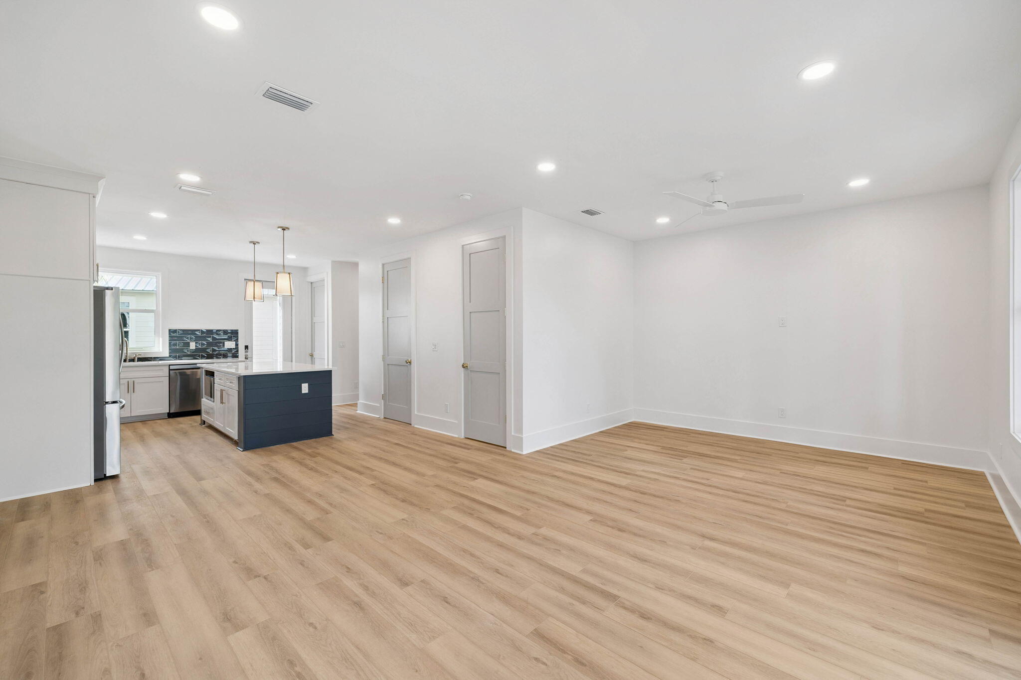 264 Dockside Drive Port St. Joe, FL 32456 - Photo 24 of 65 a view of kitchen with kitchen island a sink wooden floor and a refrigerator