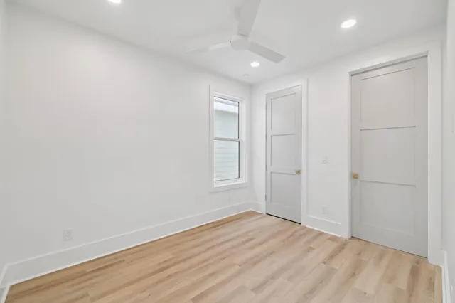 a front view of a house with swimming pool and yard