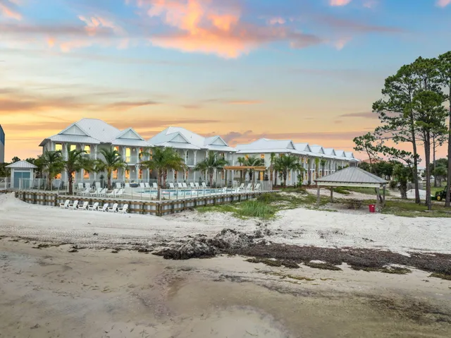 a view of swimming pool with a lake and couches in the patio