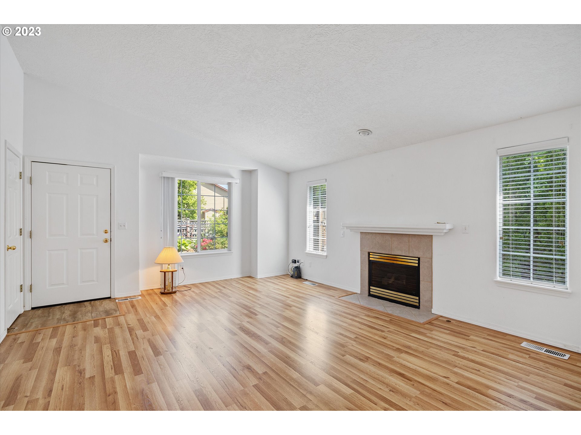 37308 Rachael Drive Sandy, OR 97055 - Photo 6 of 29 a view of empty room with wooden floor and fireplace