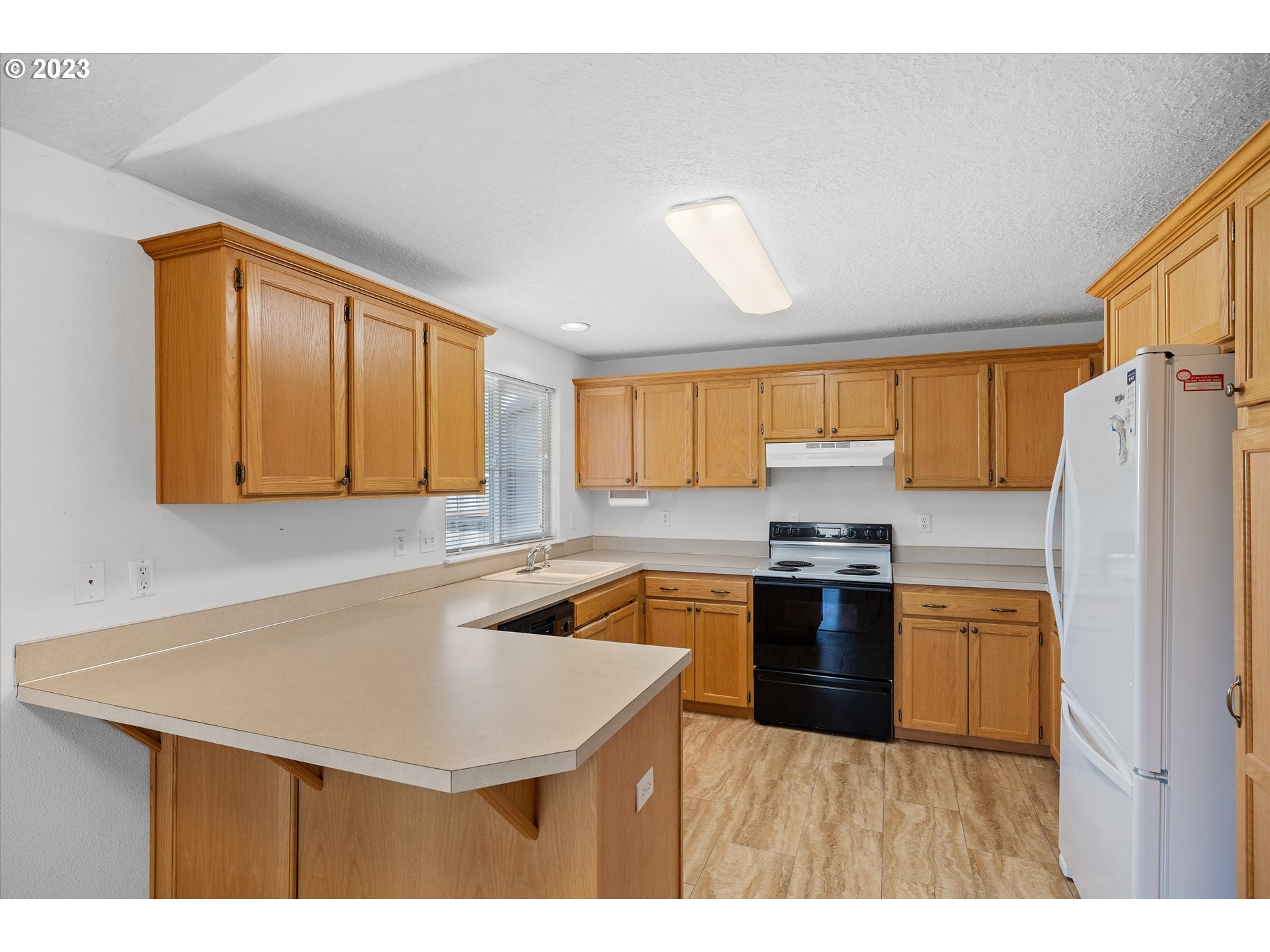 37308 Rachael Drive Sandy, OR 97055 - Photo 9 of 29 a kitchen with stainless steel appliances granite countertop a sink a stove and refrigerator