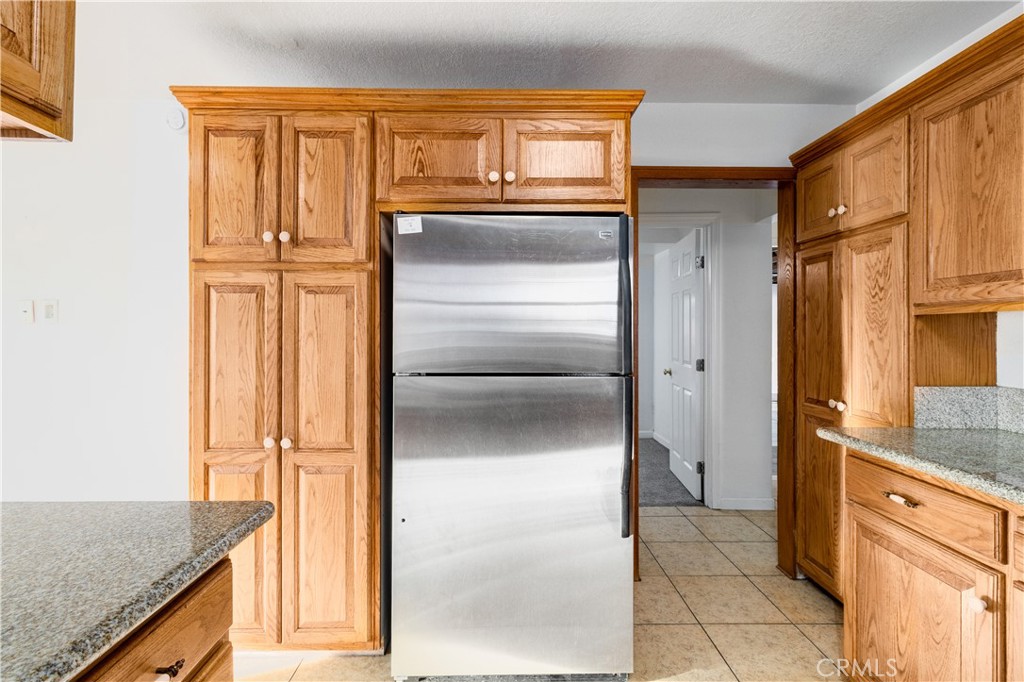 2572 Harrison Street Riverside, CA 92503 - Photo 41 of 73 a kitchen with granite countertop a refrigerator and a sink