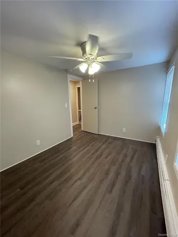 a view of a room with a ceiling fan and a ceiling fan