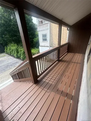 a view of balcony with wooden floor