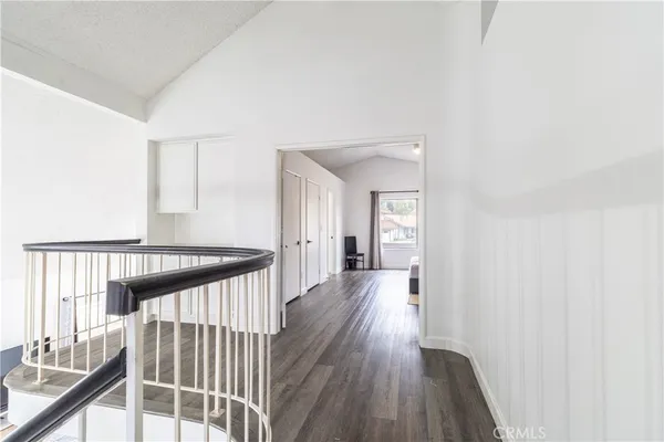 a view of a hallway view with wooden floor and staircase