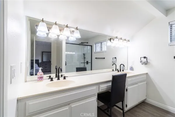 a bathroom with a sink vanity and a mirror