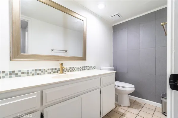 a bathroom with a sink toilet and mirror