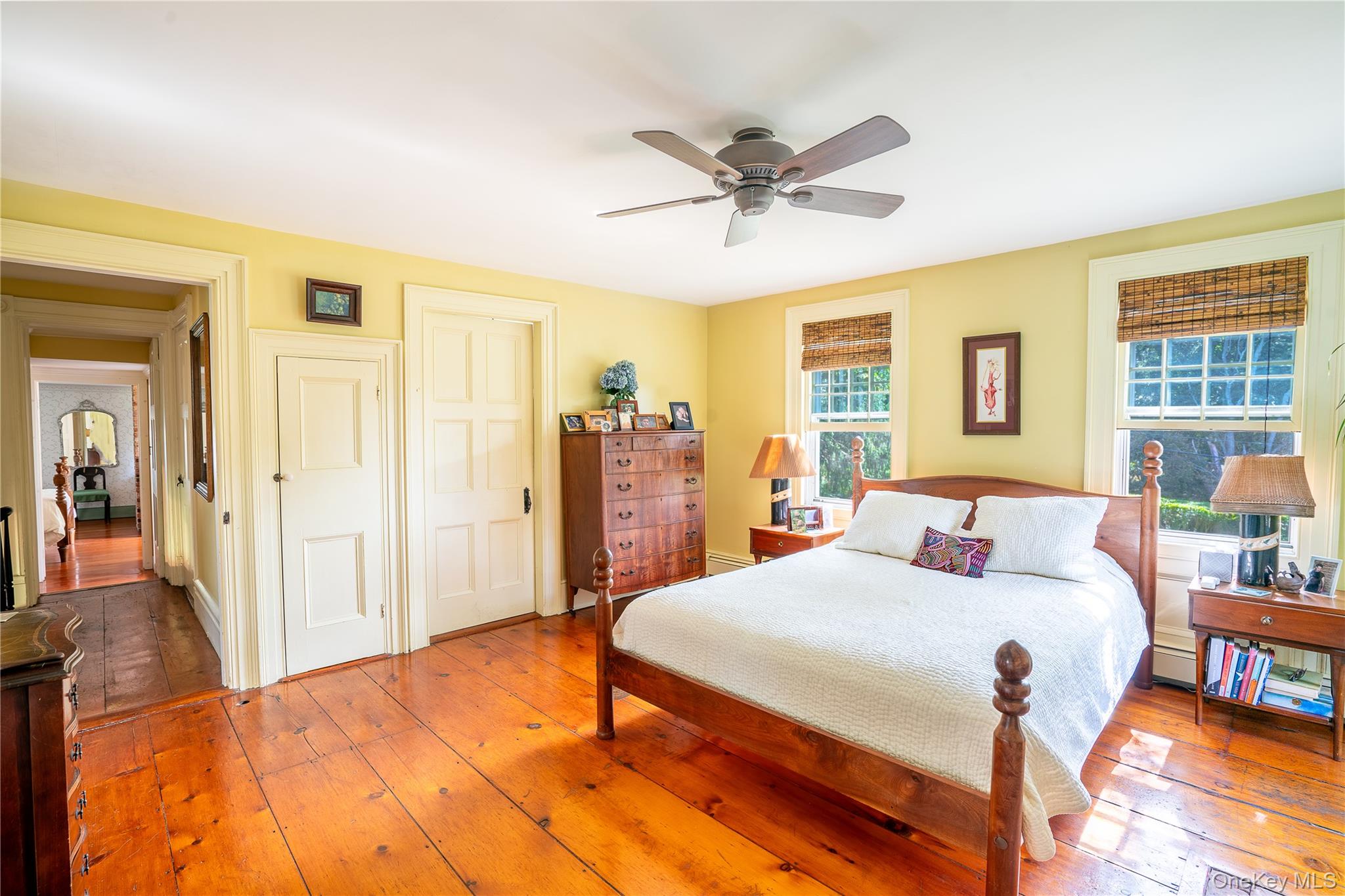 750 Reeve Avenue Mattituck, NY 11952 - Photo 26 of 41 a bedroom with a bed and wooden floor