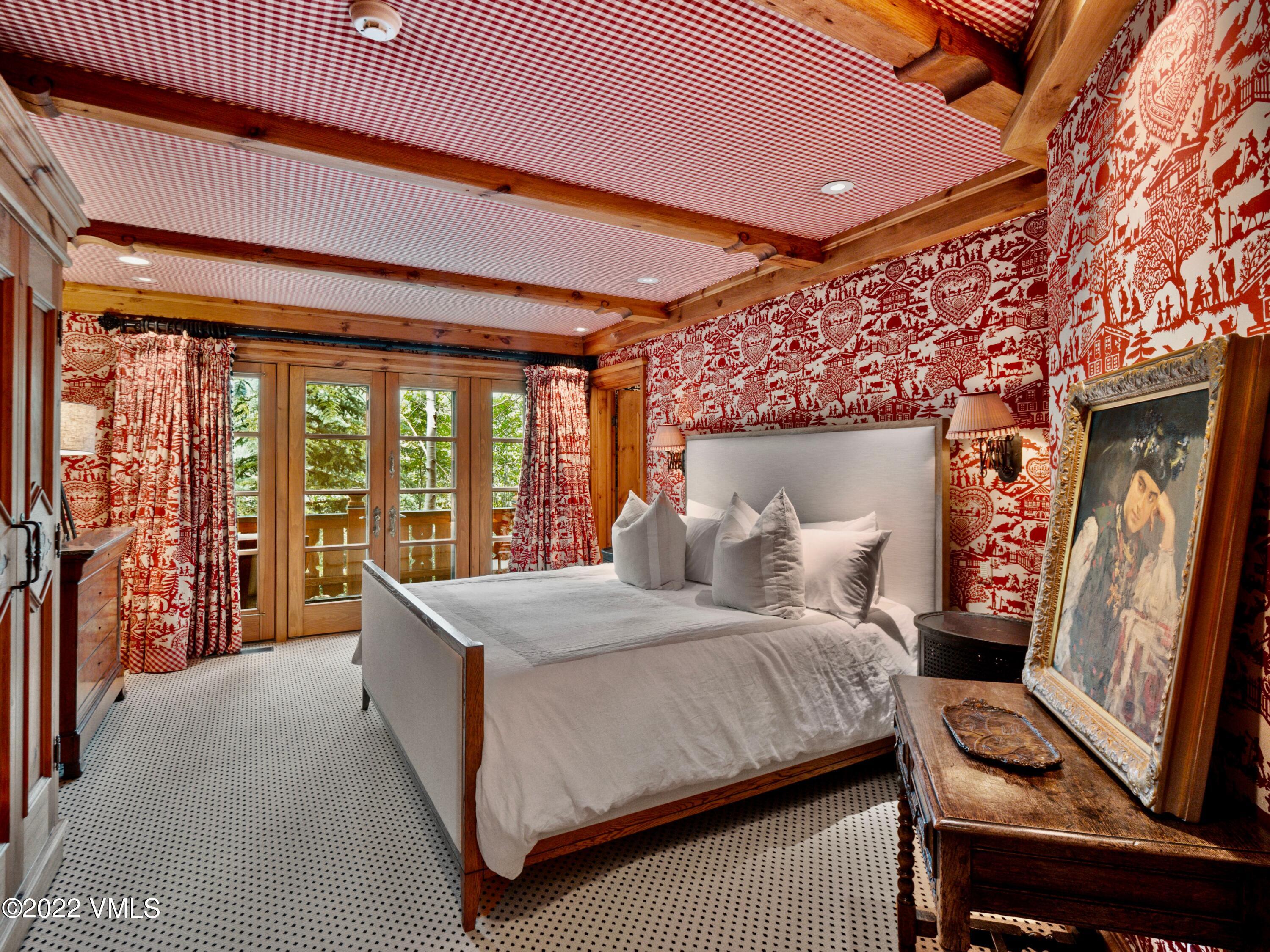 97 Rockledge Road Vail, CO 81657 - Photo 22 of 35 a bedroom with a large bed and a large window