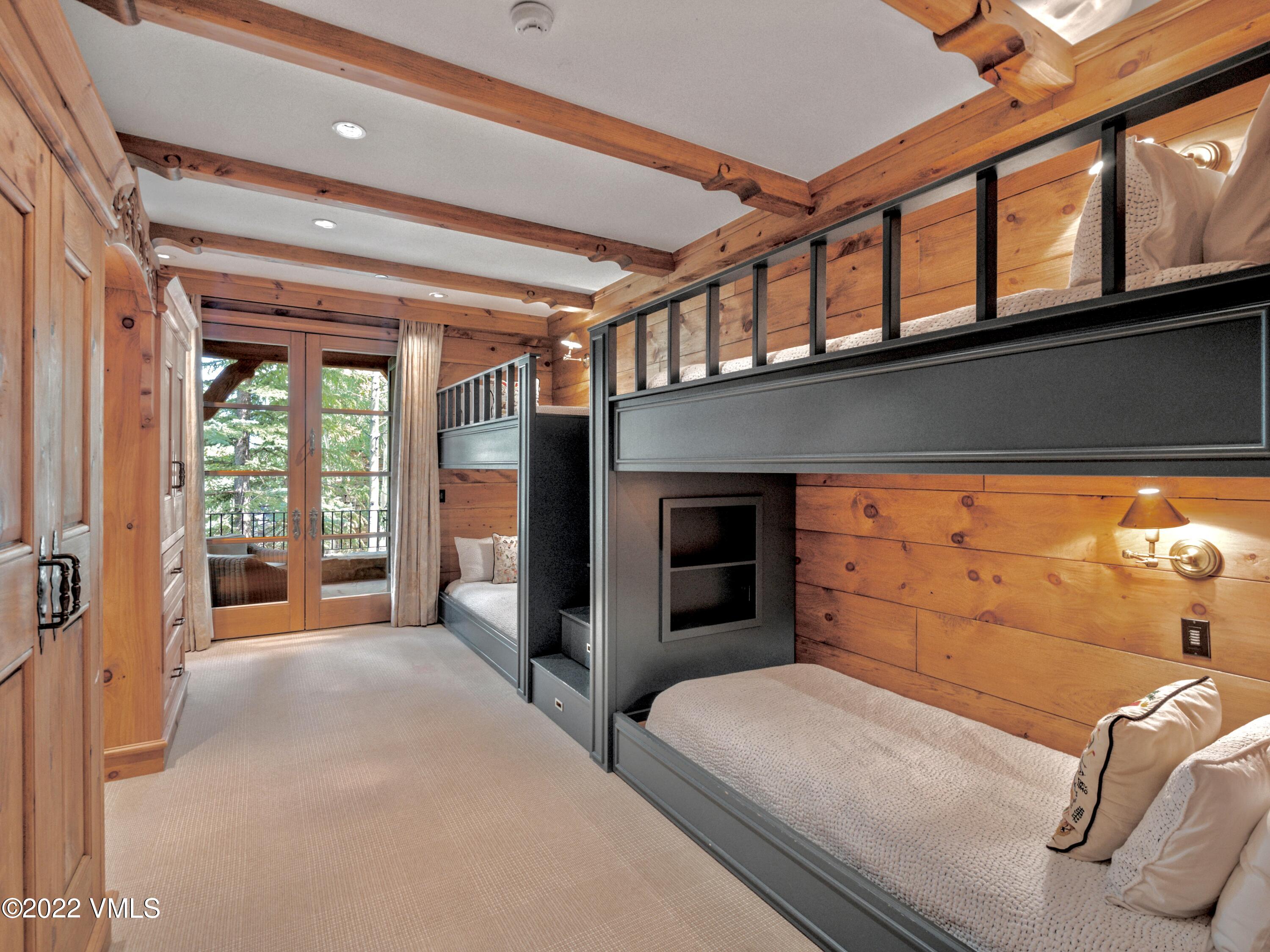 97 Rockledge Road Vail, CO 81657 - Photo 29 of 35 a bedroom with furniture and large windows