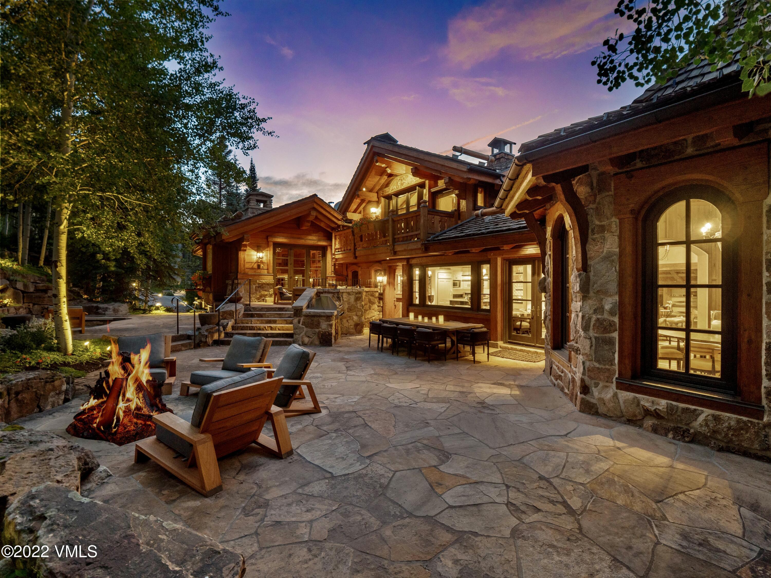 97 Rockledge Road Vail, CO 81657 - Photo 3 of 35 a view of a chairs and fire pit in backyard of a house