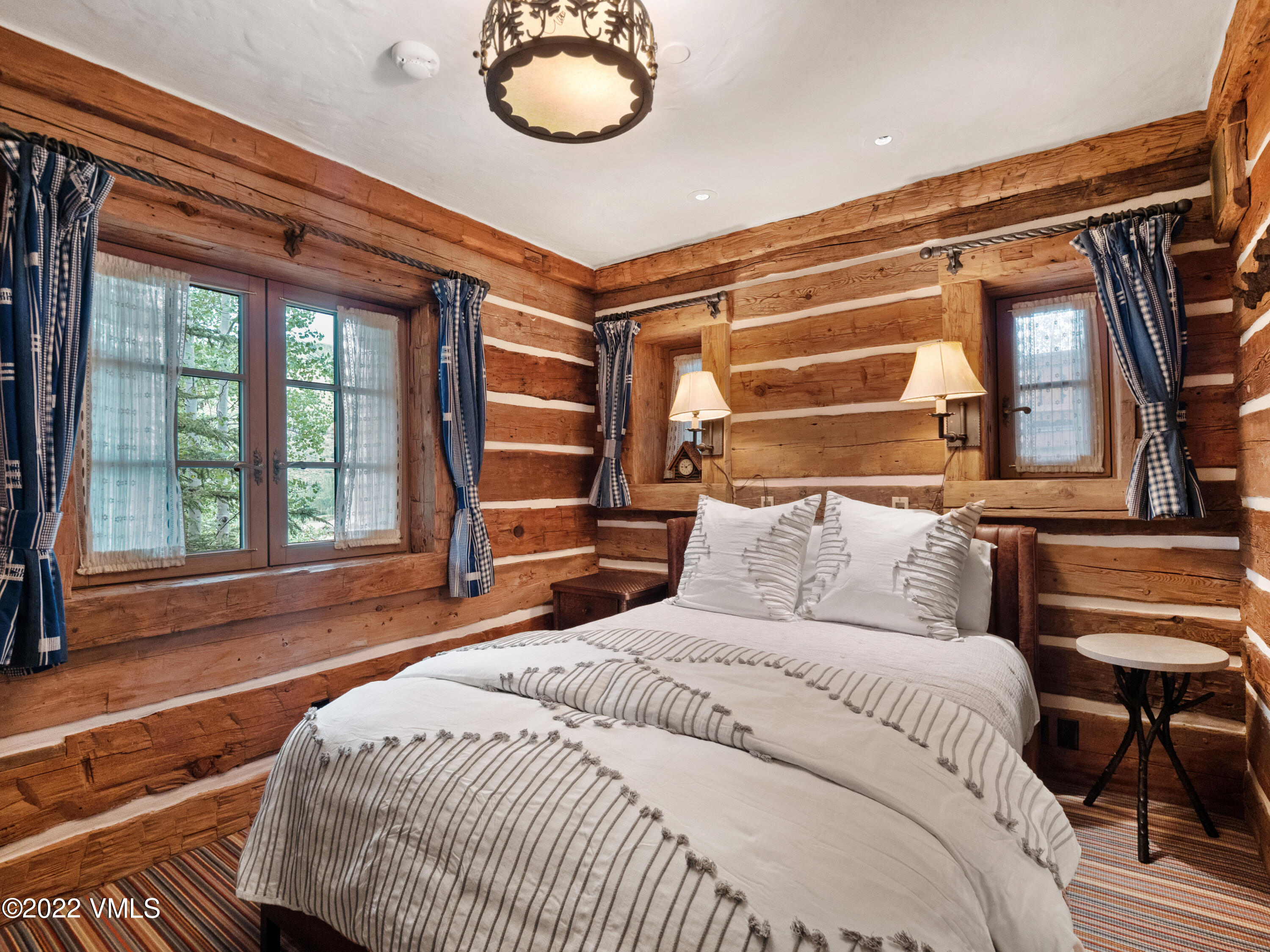 97 Rockledge Road Vail, CO 81657 - Photo 34 of 35 a bedroom with a large bed and a large window