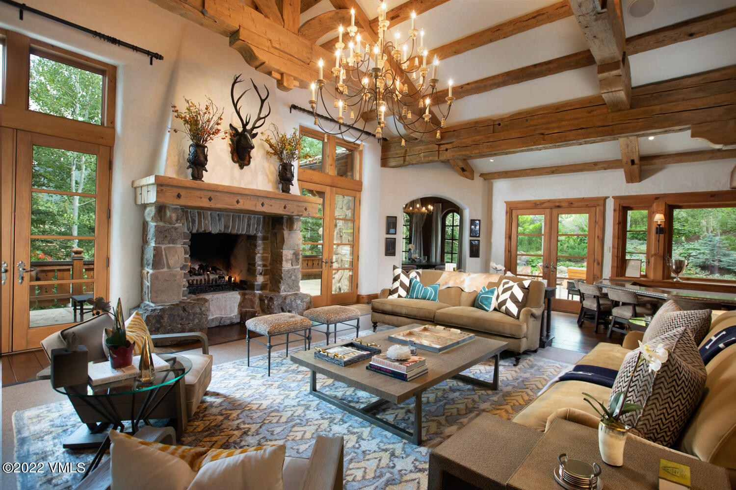 97 Rockledge Road Vail, CO 81657 - Photo 5 of 35 a living room with furniture a fireplace and a chandelier